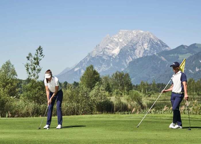 Golf course in the Schladming-Dachstein region with well-maintained greens and fairways surrounded by the Styrian mountains.