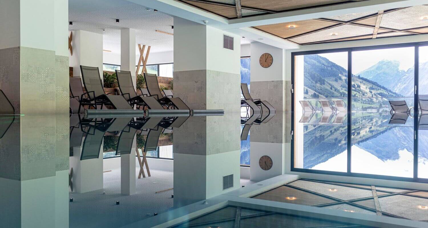 Indoor pool with views of the Goldberg Group through the glass frontage