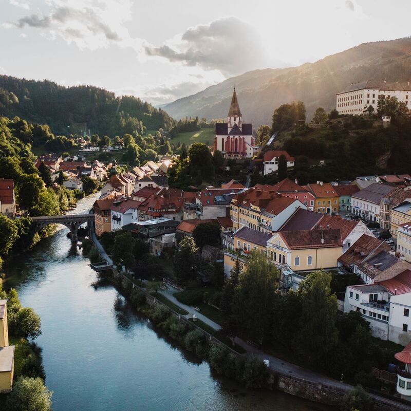 Aerial view of the historic old town of Murau in Styria, Austria, surrounded by alpine scenery.