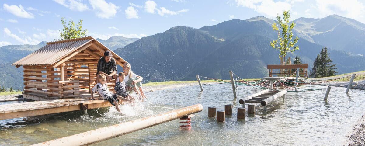 A young family cools off at the water playground.