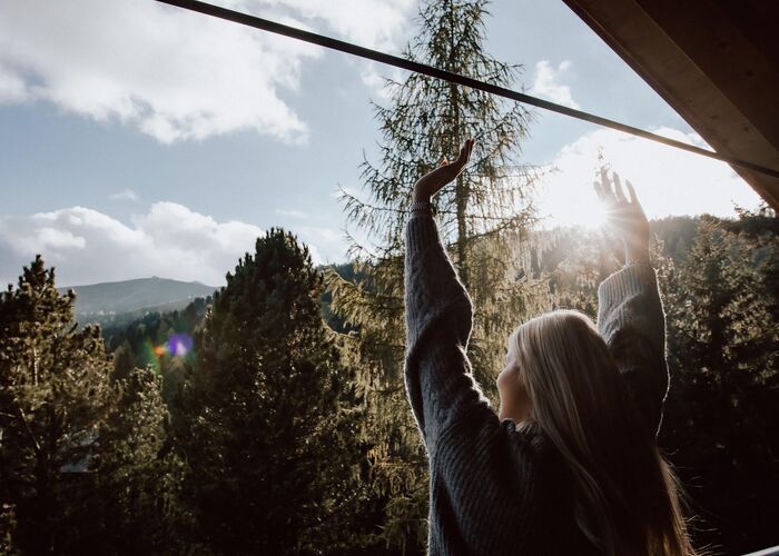 Außenansicht eines Chalets der Naturchalets Turracher Höhe by ALPS RESORTS, idyllisch zwischen Bäumen gelegen und umgeben von der alpinen Natur der Turracher Höhe.