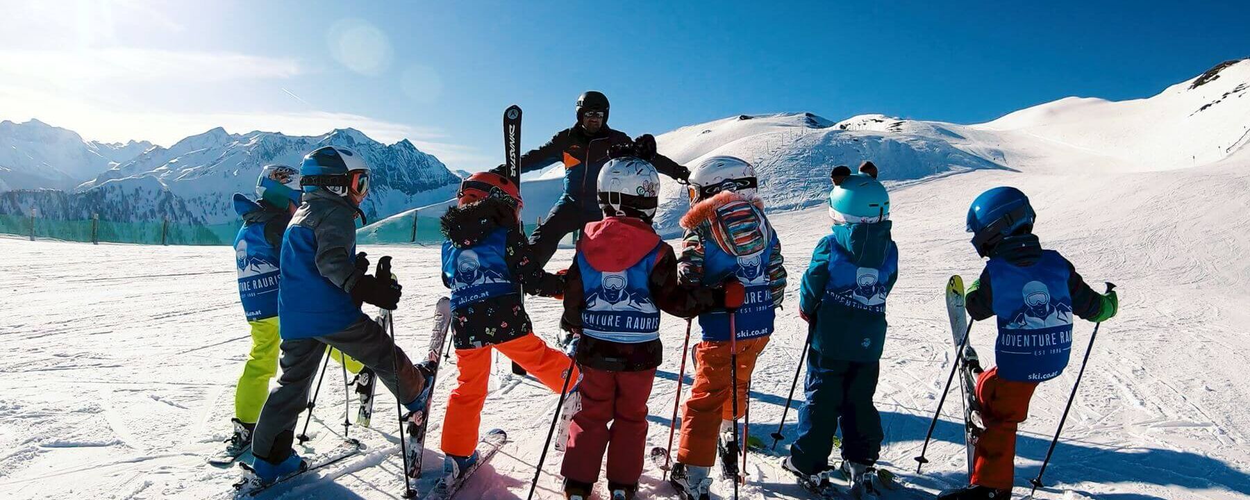 Ski instructor with a children's ski group on the slopes