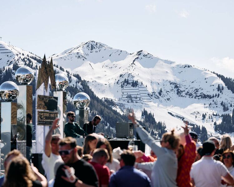 DJs and partying crowds against a wintry mountain backdrop at the White Pearl Mountain Days