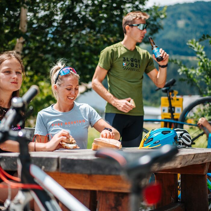 Family taking a break after a sporting activity and relaxing together outdoors.
