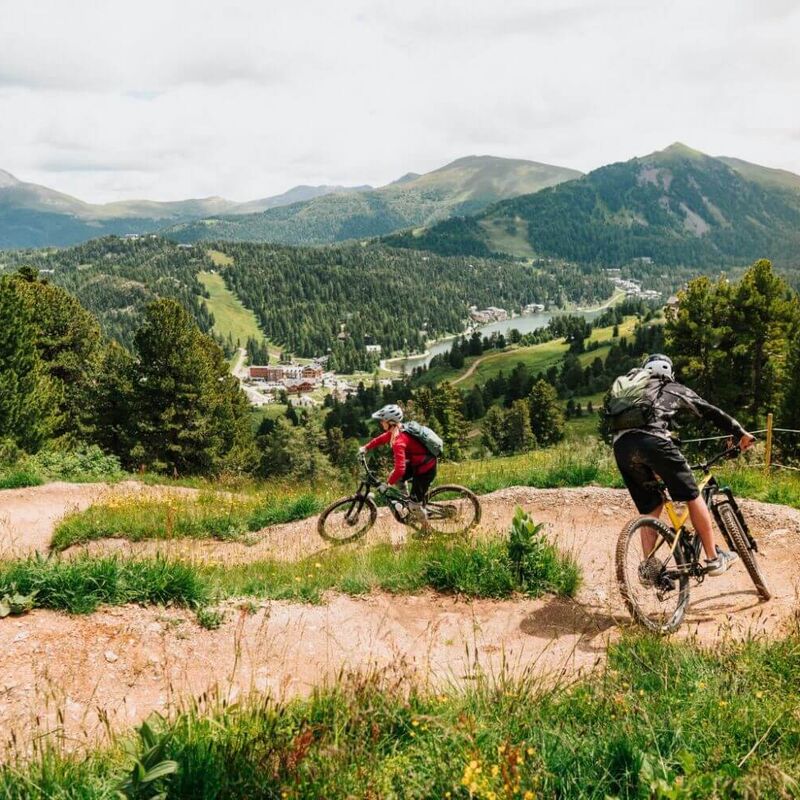 Mountain bike flow trail on the Turracher Höhe, surrounded by alpine scenery on a sunny day.