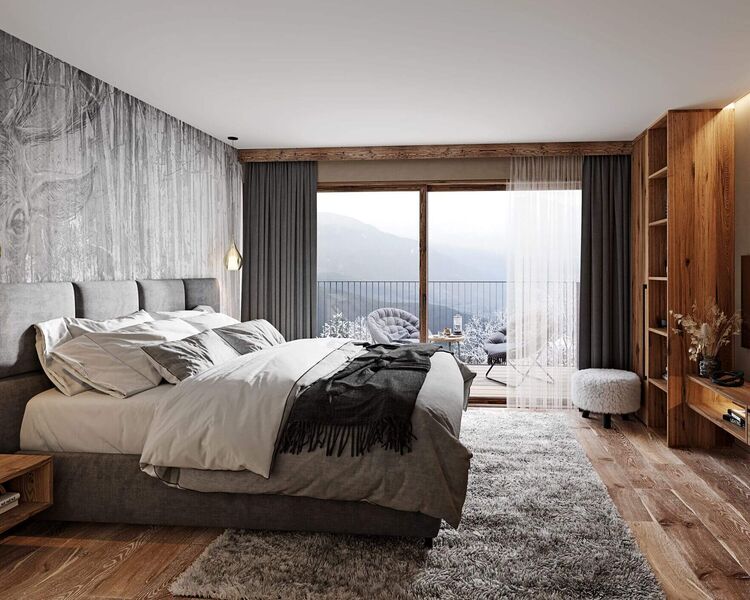 Schlafzimmer mit Doppelbett und Bergblick in den Ladis Suites