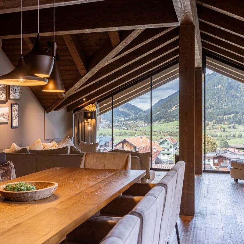 Living area with floor to ceiling windows and mountain views