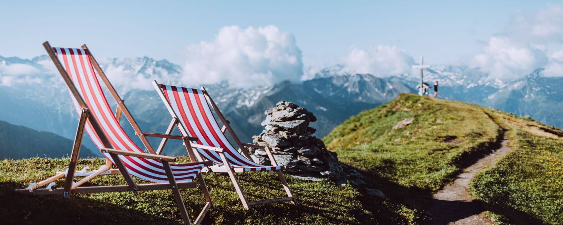 Two deckchairs positioned near a summit cross