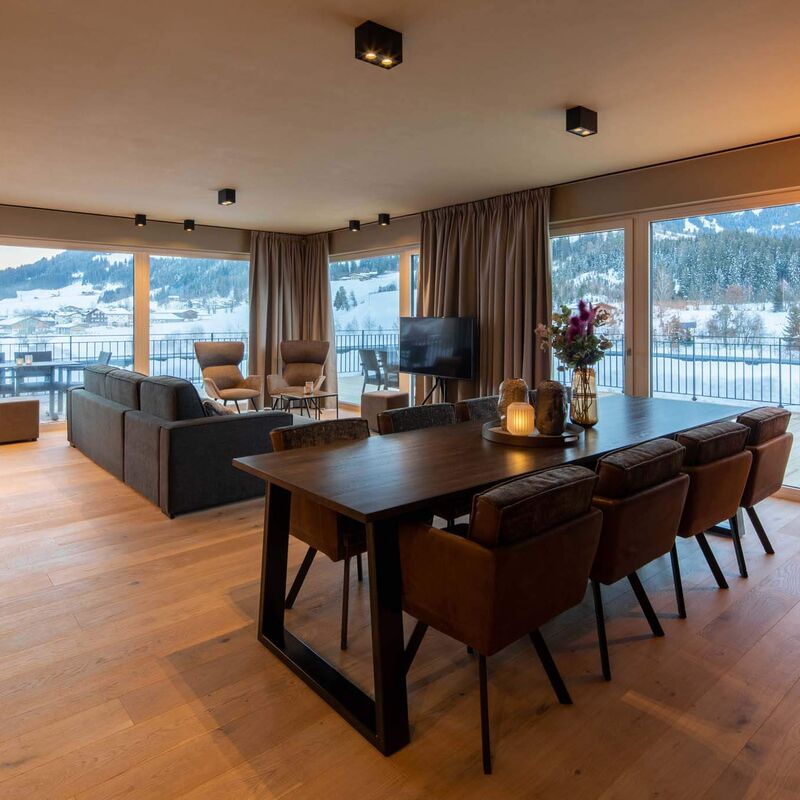 Spacious living and dining area with window front in the Berg & Golf Resort Westendorf