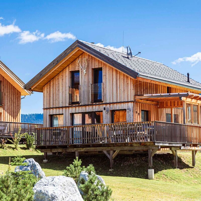 Wooden holiday homes with a terrace set in greenery