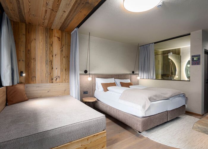 Sofa bed with a double bed and a view into the bathroom