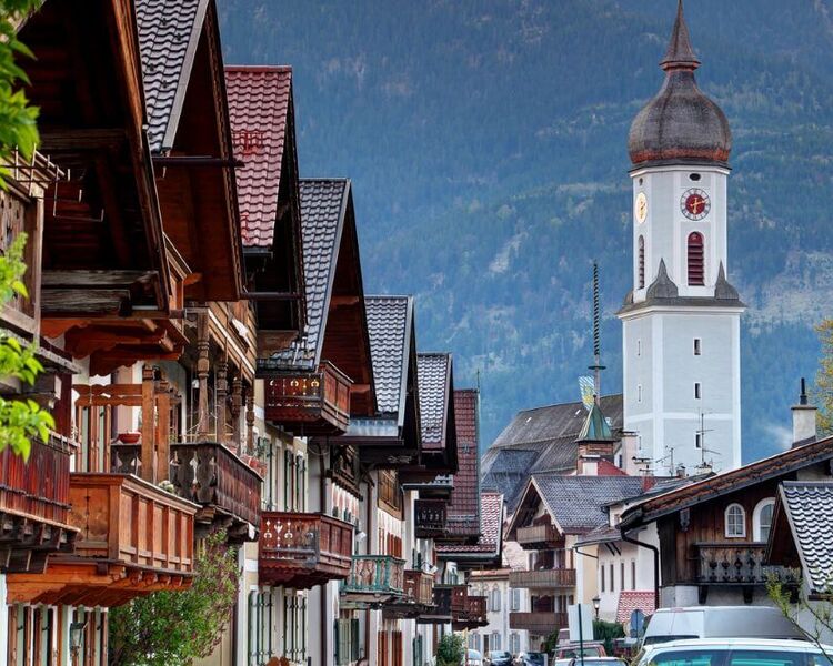 Old town street in Garmisch-Partenkirchen with wooden balconies and church tower