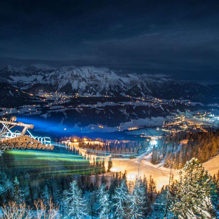 Night view from Hochwurzen with illuminated slopes and mountains in Schladming Dachstein.