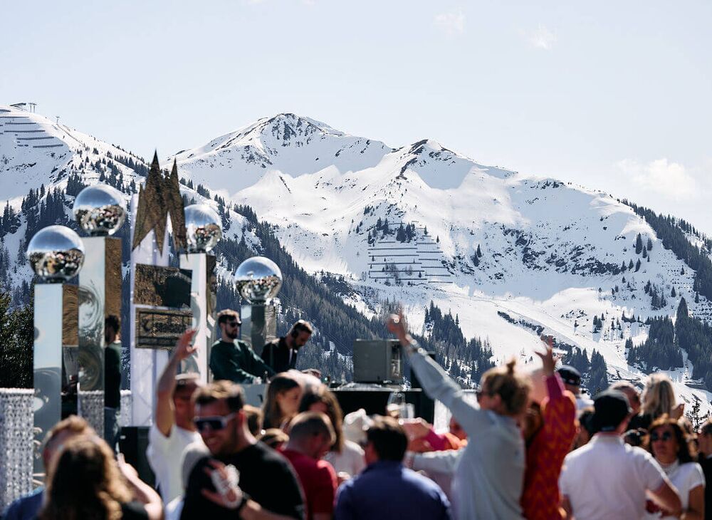 DJs und feierndes Publikum vor einer winterlichen Bergkulisse bei den White Pearl Mountain Days