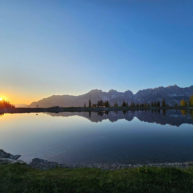 Astbergsee lake at sunset with a view of the Wilder Kaiser