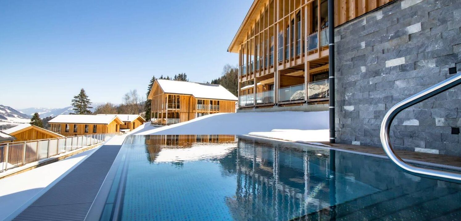 Moderne, schneebedeckte Chalets mit privatem Outdoor Pool.