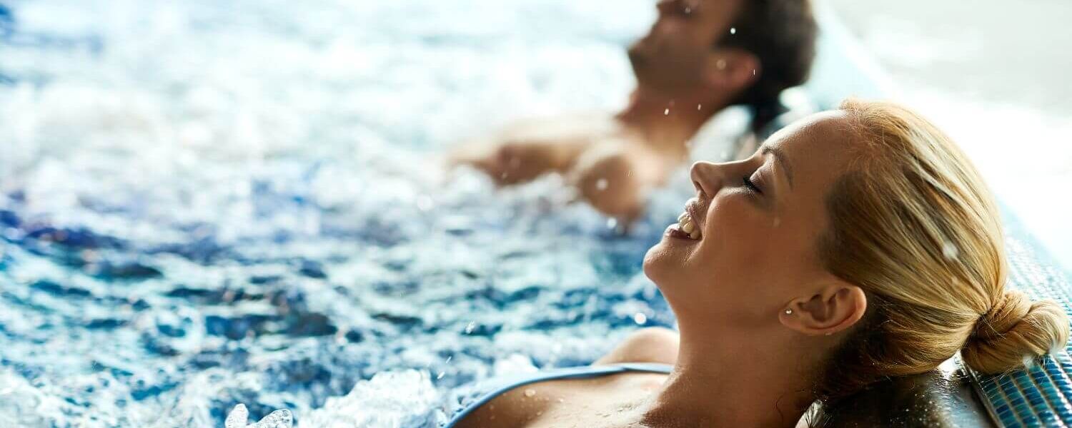 Couple relaxing in the whirlpool of a thermal spa
