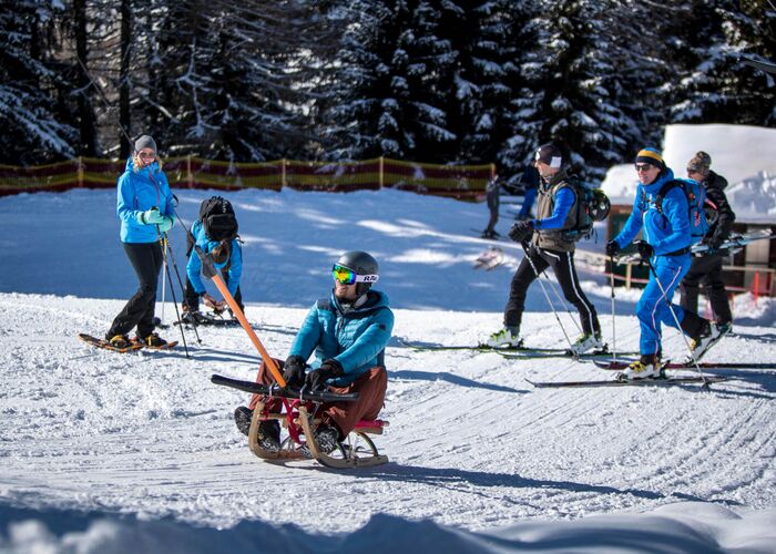 People sledding uphill at Almdorf Tonnerhütte, Zirbitzkogel Grebenzen Nature Park