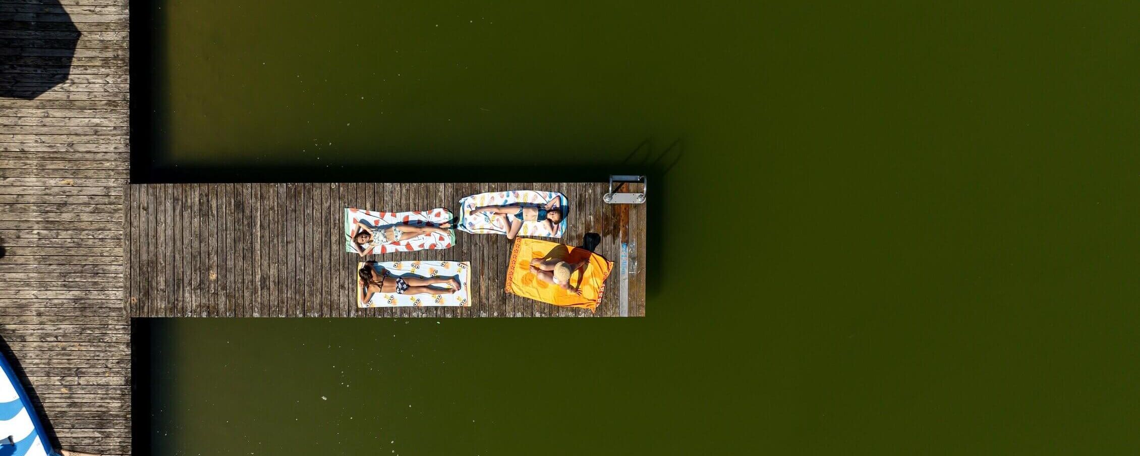Aerial view of the wooden pier at Graslupp Pond in Zirbitzkogel Grebenzen Nature Park