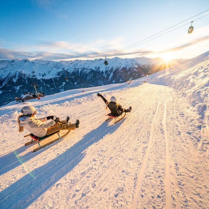 Two tobogganists on the descent of the Wildkogel toboggan run