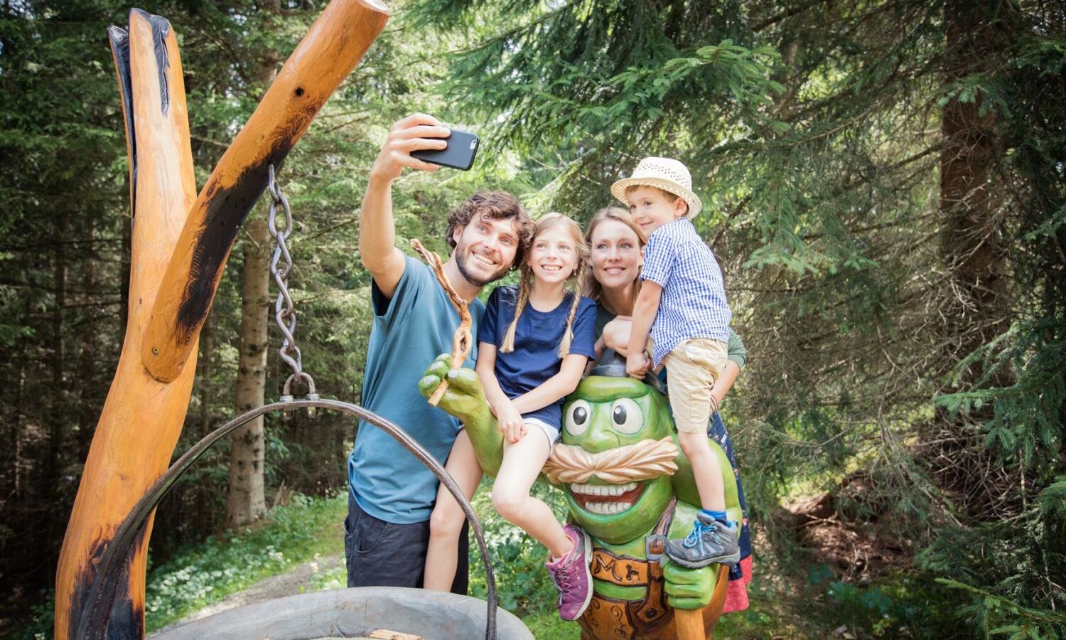 Family captures a holiday moment on an adventure hiking trail in Tyrol with a selfie
