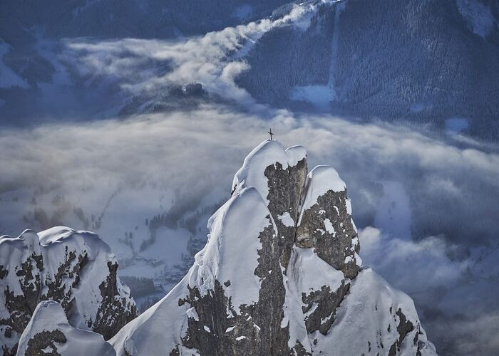 Helicopter shot of a summit cross in Saalbach Hinterglemm