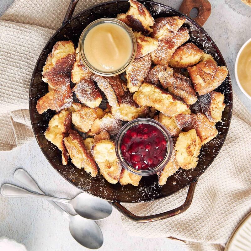 Fluffy Kaiserschmarrn topped with jam and powdered sugar