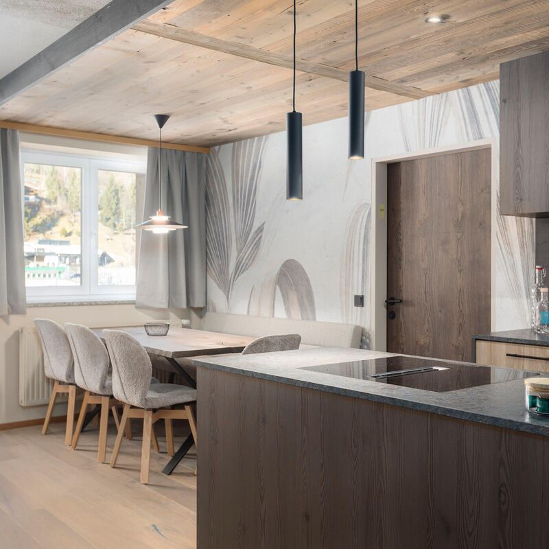 Living area of a modern holiday apartment with a large kitchen and dining table