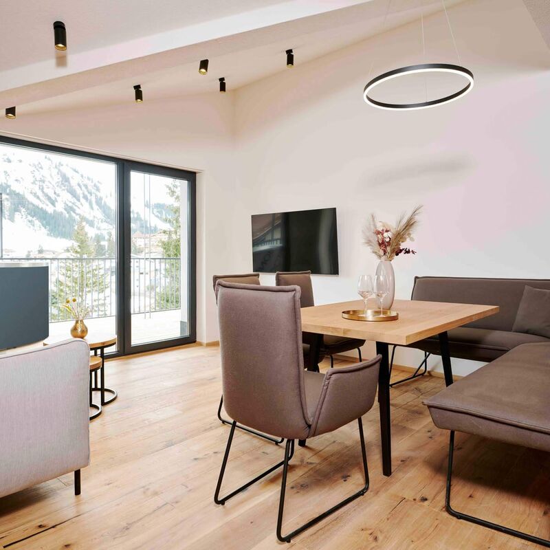 Bright living and dining area of a holiday apartment