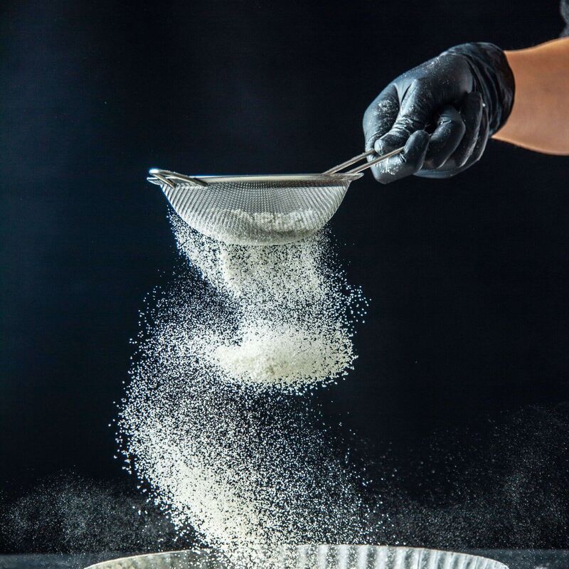Powdered sugar sprinkled over freshly cooked Kaiserschmarrn