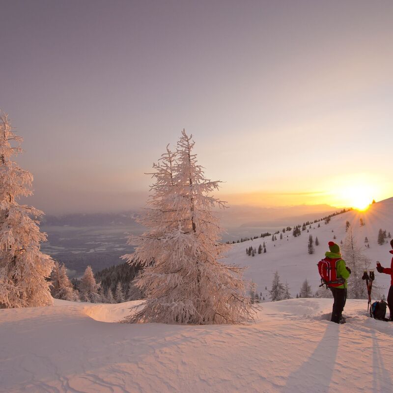 Sunrise winter tour through deep snowy mountain landscapes on the Gerlitzen.