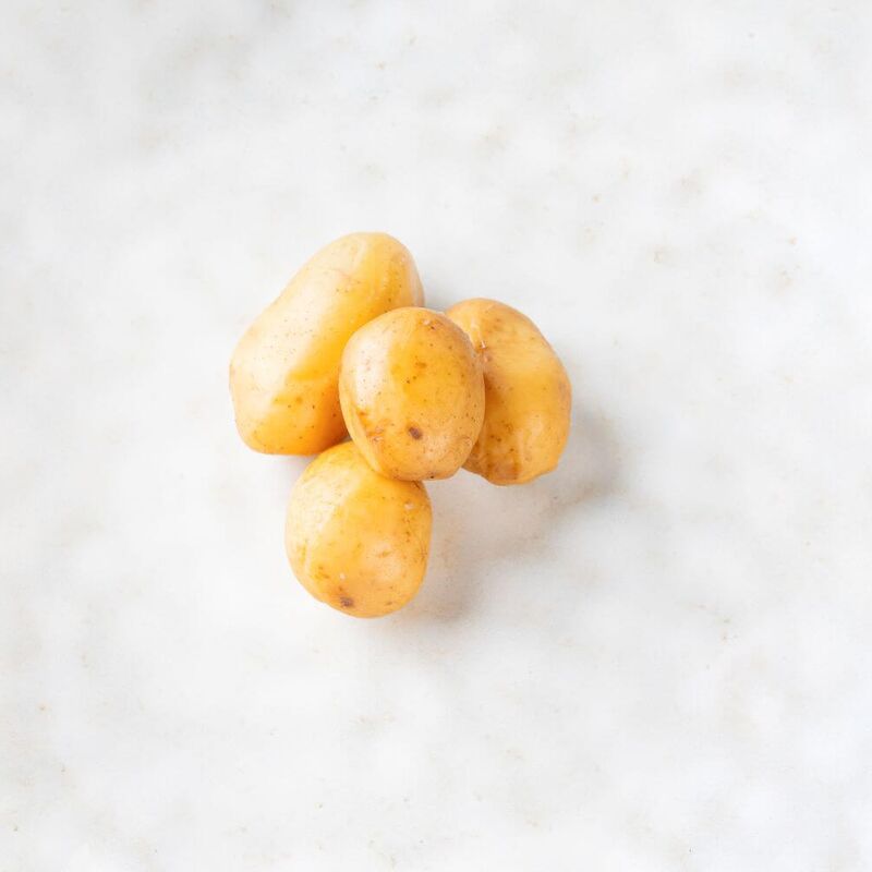 Four unpeeled potatoes