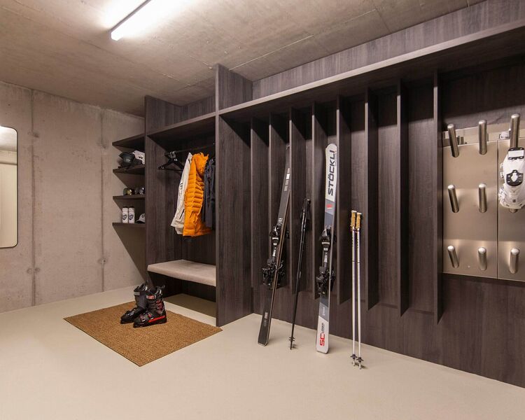 Ski storage room with ski racks and heated boot dryers at ALPS RESORTS.
