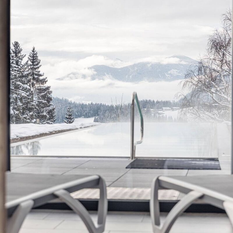 2 Liegestühle im Ruhebereich mit Blick auf den beheizten Outdoor Pool