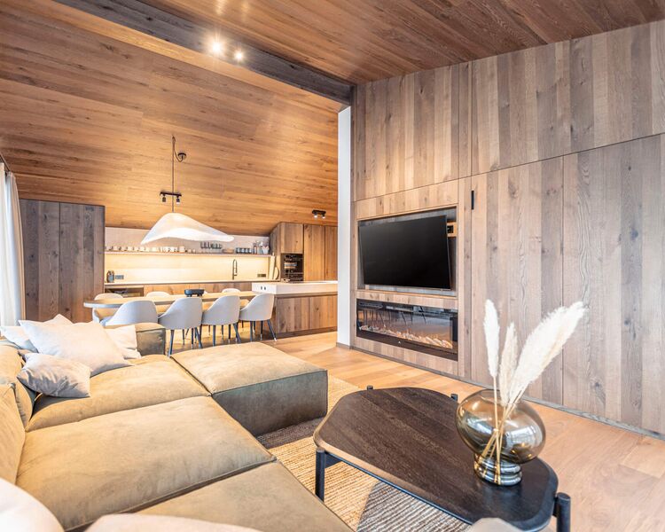 Modern living room with kitchen in the background