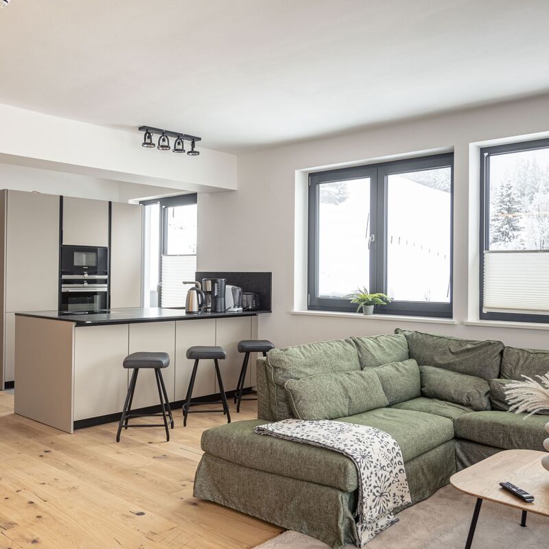 Bright living area with kitchenette in a modern holiday apartment