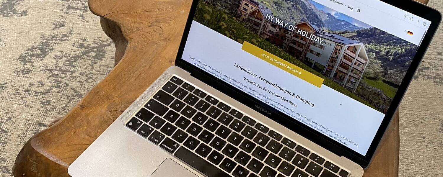 Someone is using a laptop to look for suitable holiday accommodation on the ALPS RESORTS website.