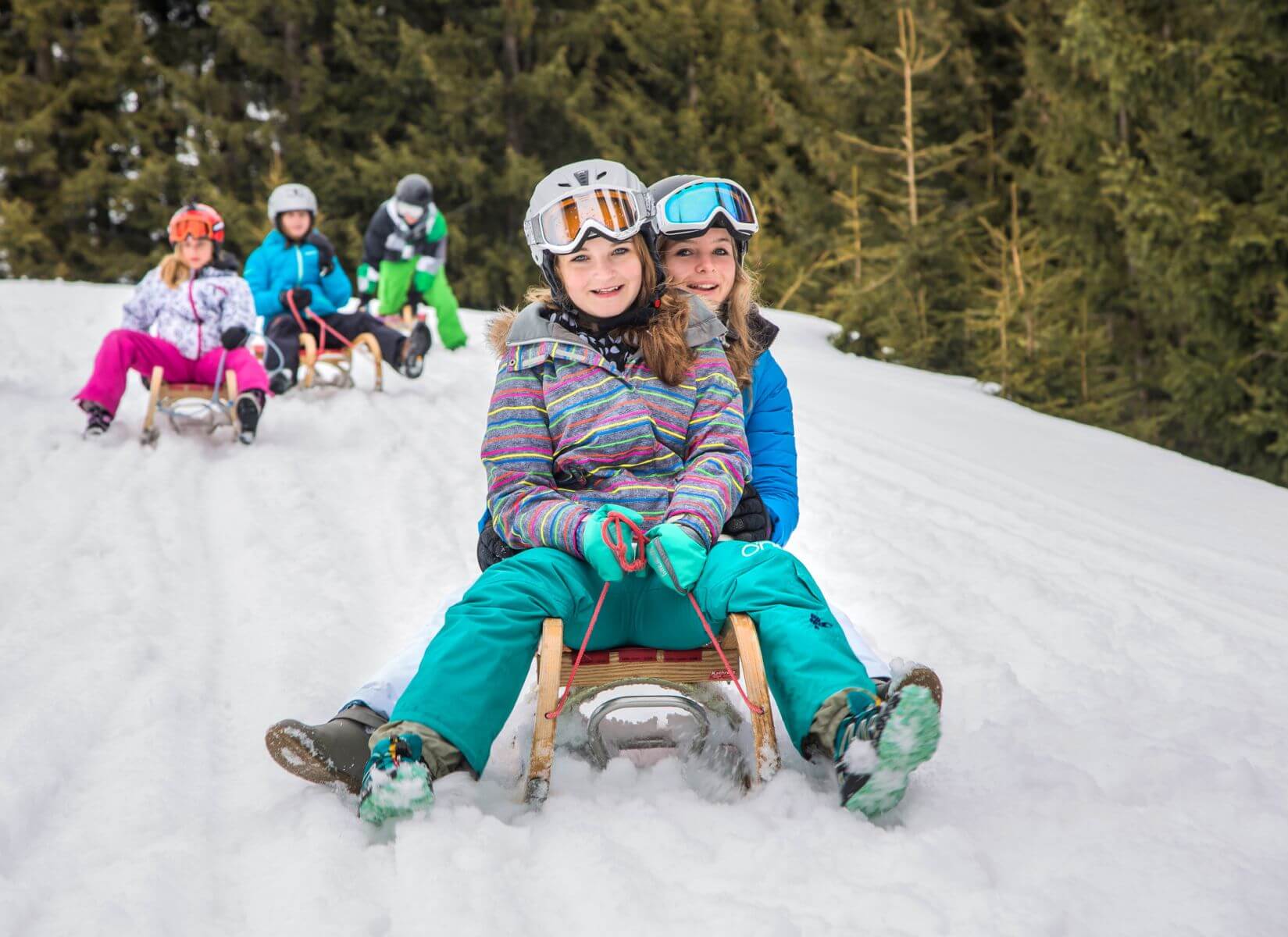 Young group of friends tobogganing