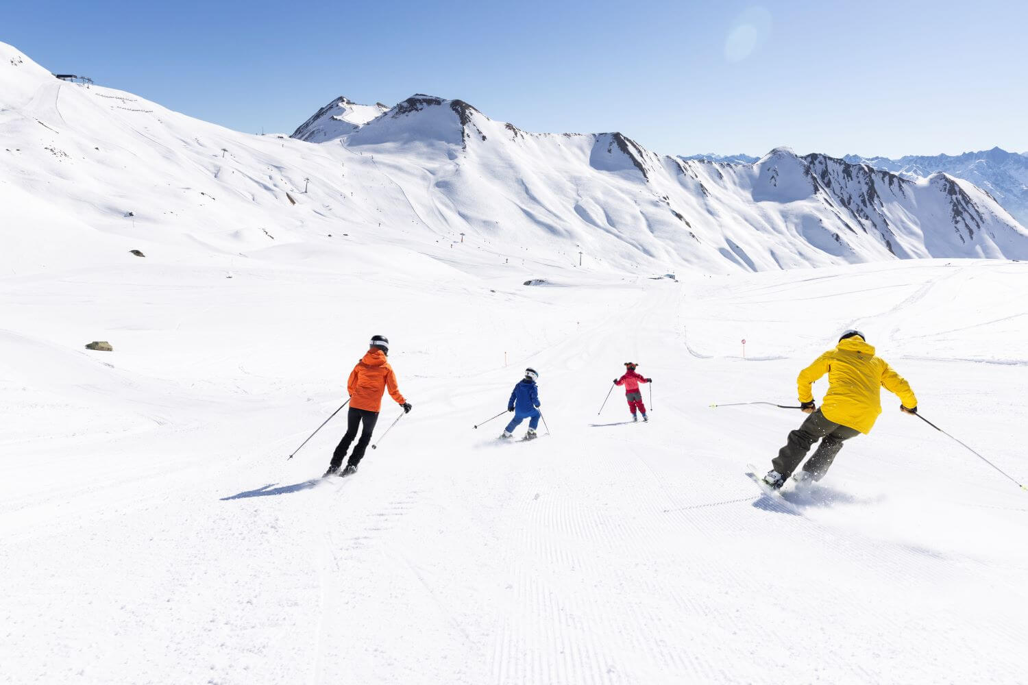 Parents with children skiing on a wide slope